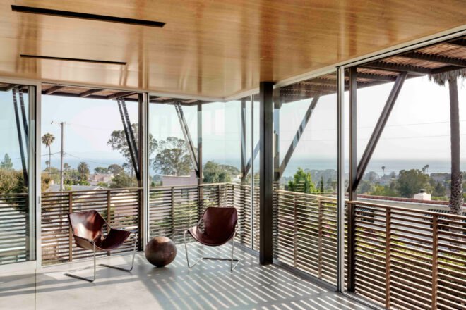 room with glass walls and two chairs