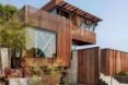 tall staggered home with wood screens
