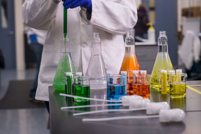 person mixing colorful cleaning solutions