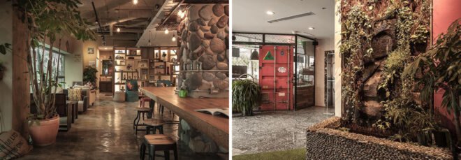 Communal area of youth hostel with seating and living green wall