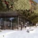 building with glass walls topped with greenery