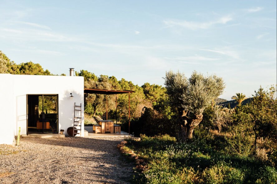 gravel leading to white home with covered patio