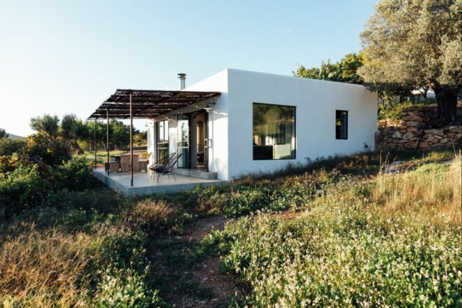 White, cube-like structure with front porch