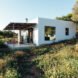 White, cube-like structure with front porch