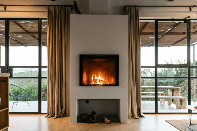 fireplace with two large windows on either side