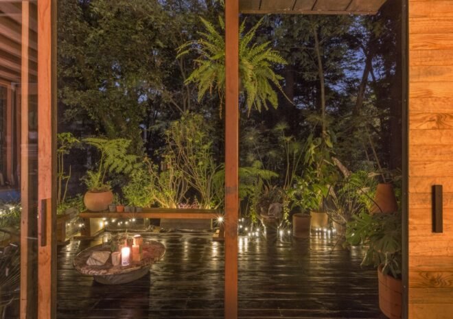night view of the outdoors of the home with lights
