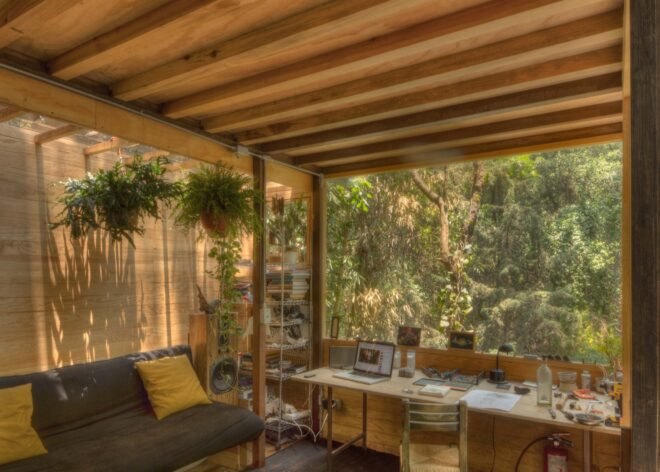 music studio with drums and couch outdoor patio and large windows