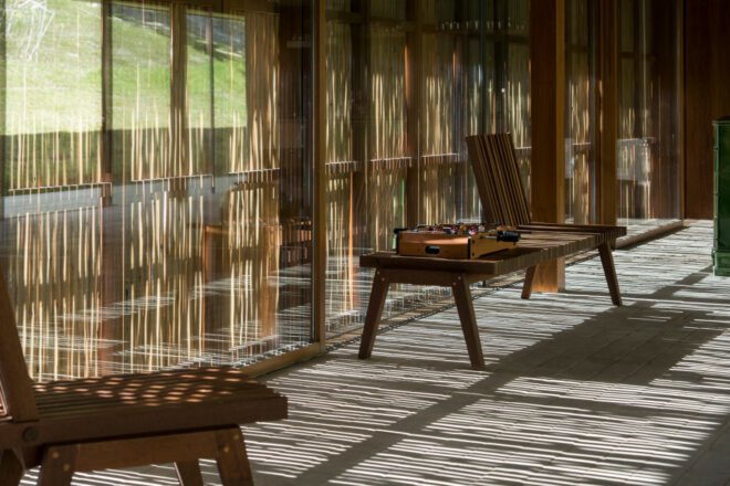 chairs beside screens made out of eucalyptus branches
