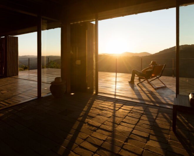 roof with glass walls leading to a large wooden deck