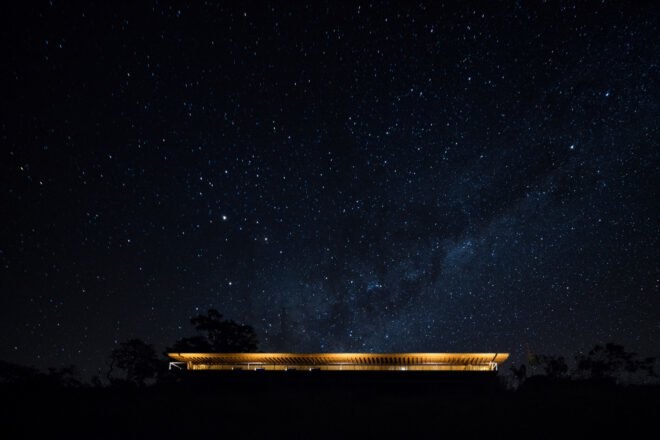 long, low-lying home lit up at night