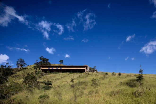 long wood home at the top of a hill