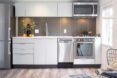 bright kitchen with wood floors and white cabinets