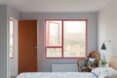 bedroom with large window framed in red