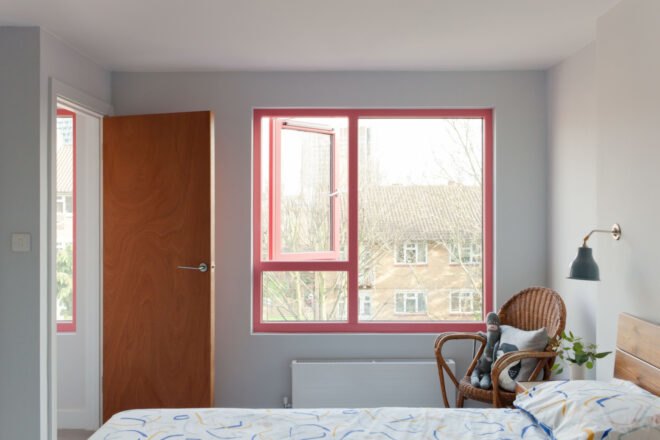 bedroom with large window framed in red