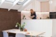 woman in kitchen with dining area on floor below