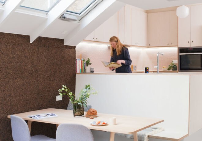 woman in kitchen with dining area on floor below