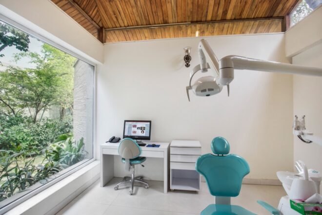 white dentist office with blue dentist chair