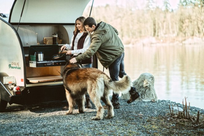 man and woman preparing a meal in an outdoor kitchen