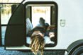 two people lying down inside teardrop trailer