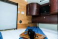 interior space with bed and shelving unit with TV