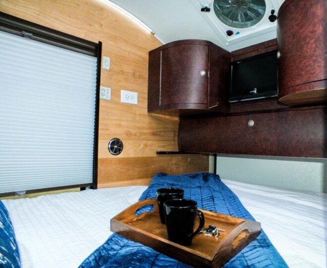 interior space with bed and shelving unit with TV