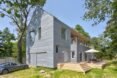 home with gray cedar siding and second-story deck