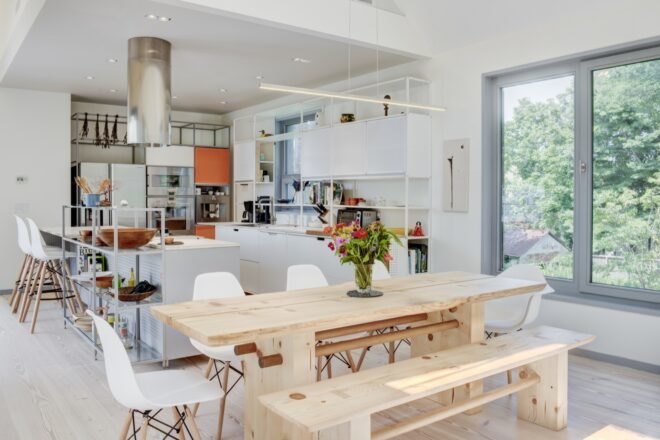 kitchen and dining room with wood table and white cabinets