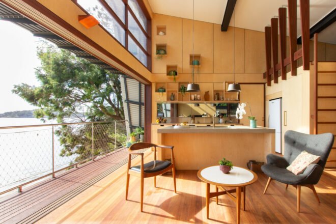 interior living space with raised wall leading out to wooden deck