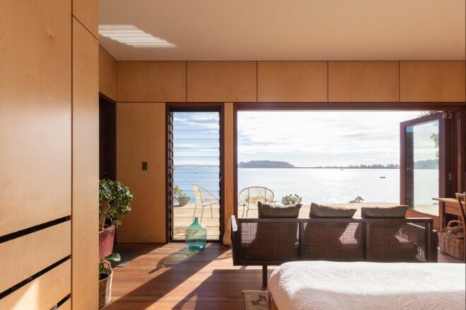 couch facing glass wall with ocean views