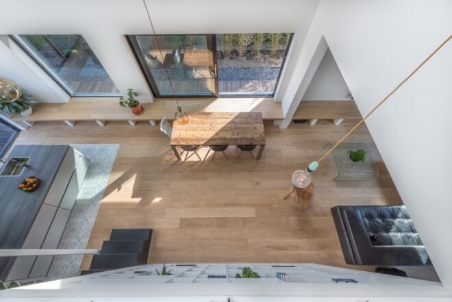 wood dining table with wood floors positioned near a window