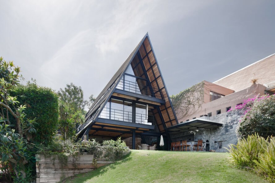 black A-frame home with glass walls