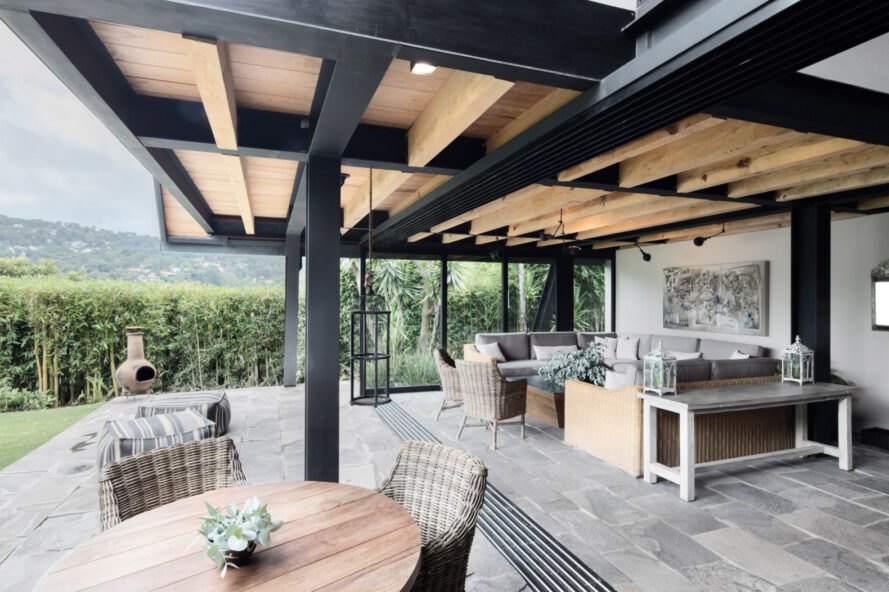 open-air living room with gray wrap-around couch