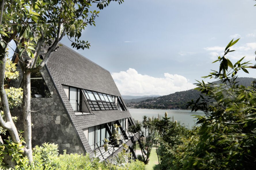 side of A-frame home and views of a lake