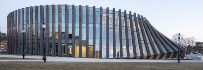 copper and glass building with facade that looks like falling dominoes