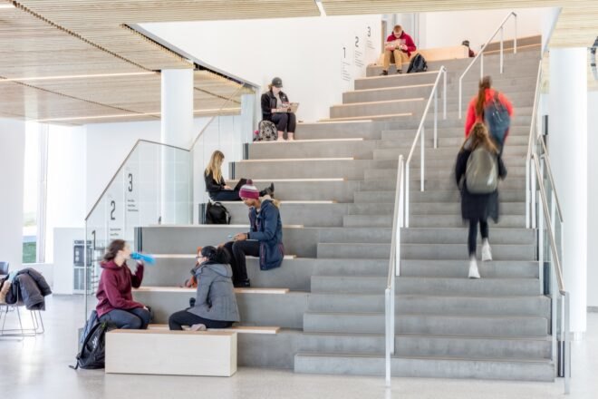 students sitting on gray steps