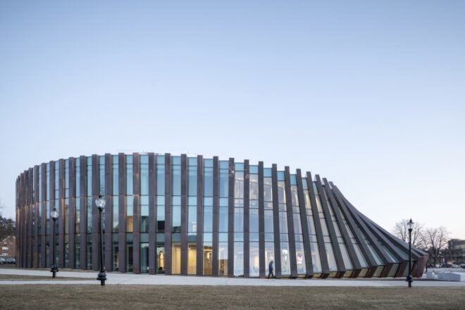 copper and glass building with facade that looks like falling dominoes