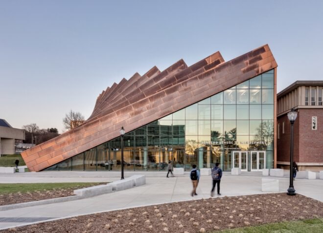 people walking outside copper and glass building