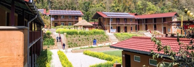 rammed earth school buildings topped with solar panels