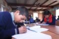 students writing in notebooks