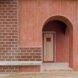 rounded doorway to a brick home
