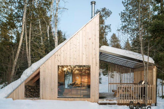 wood micro home with sloped roof in wintery forest