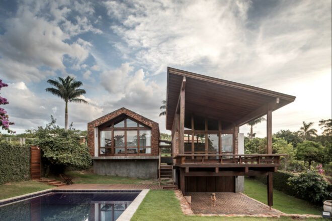stone and brick home with large pool