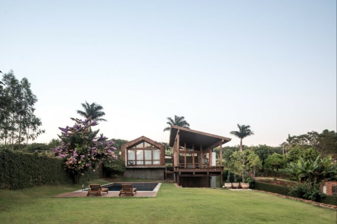 home with pitched roof and wooden deck