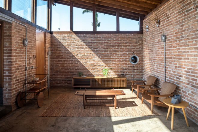 living room with brick walls and wood furnishings