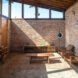 living room with brick walls and wood furnishings