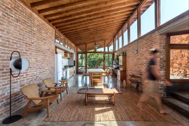 brick room with lounge chairs and a dining set
