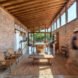 brick room with lounge chairs and a dining set