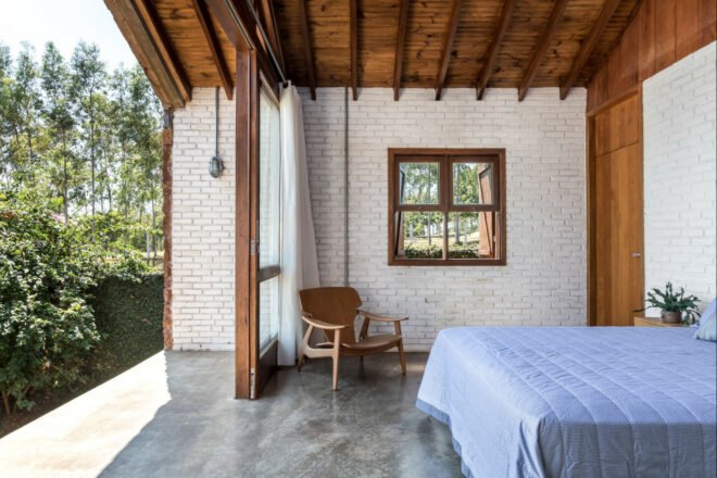bedroom with brick walls and outdoor deck