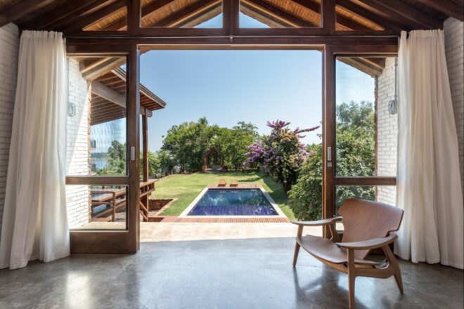 interior living space looking out over pool and large garden
