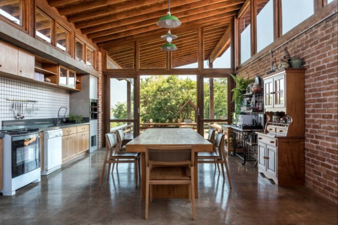wood dining table near a wood and white kitchen